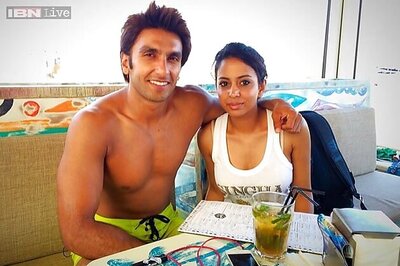 Snapshot: Ranveer Singh chills on the Barcelona beach in yellow trunks as he poses with a fan