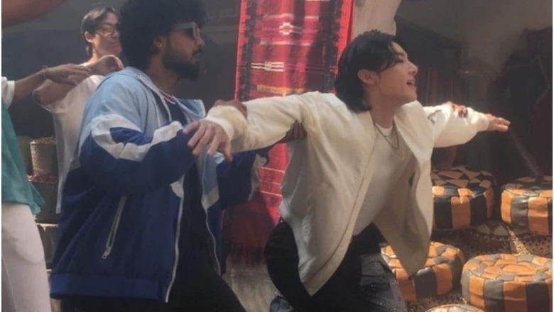 BTS: Jungkook Spotted Shooting in Qatar, Makes Heart Gestures and Waves to Fans